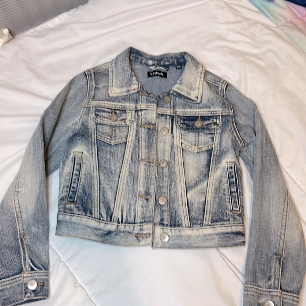 Kidpik size 7/8 girls washed denim jacket with pockets. Button front/ back tabs